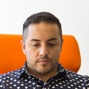 Headshot of man in a polkadot shirt.